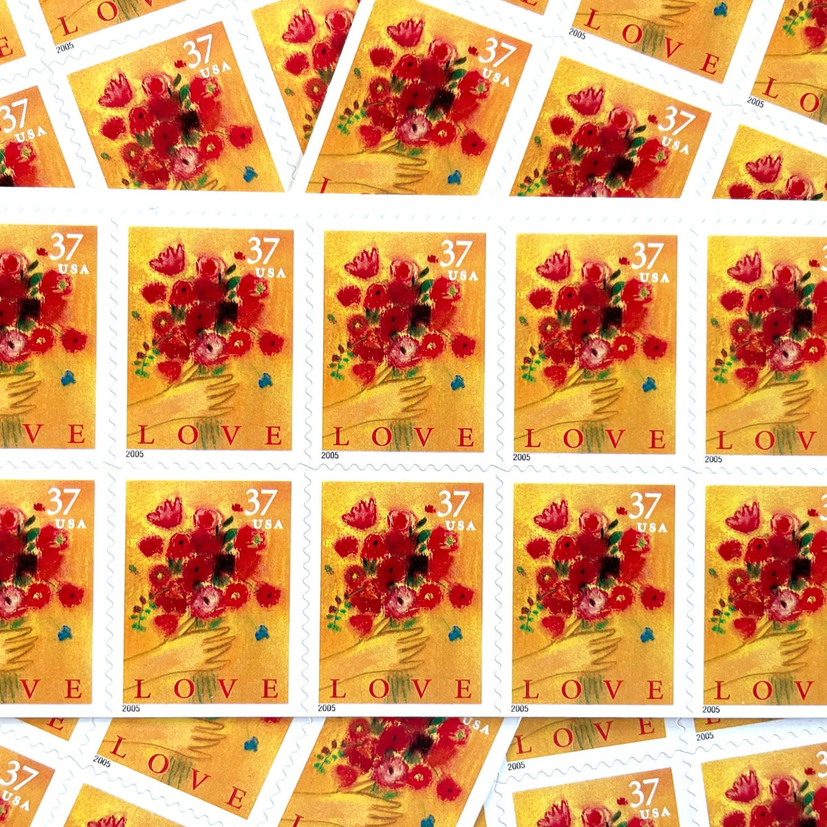 Love Bouquet postage stamps from 2005 featuring a hand offering colorful spring flowers against a yellow-gold background on vintage unused 37-cent USPS postage, Scott 3898.
