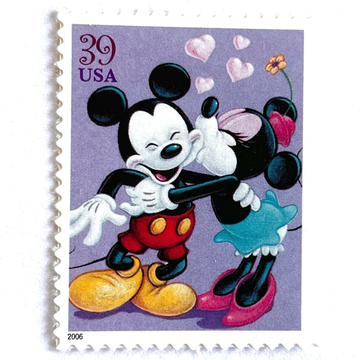 Mickey and Minnie Mouse postage stamp from 2006 featuring Minnie kissing Mickey on the cheek on vintage unused 39-cent USPS postage.