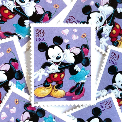 Mickey and Minnie Mouse postage stamps from 2006 featuring Minnie kissing Mickey on the cheek on vintage unused 39-cent USPS postage.
