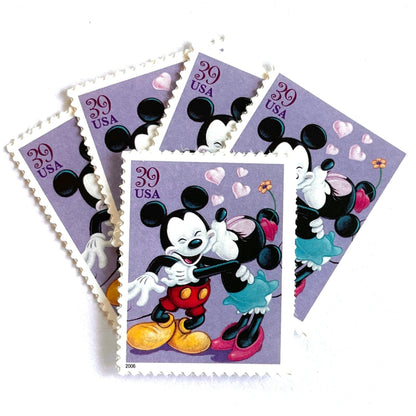 Mickey and Minnie Mouse postage stamps from 2006 featuring Minnie kissing Mickey on the cheek on vintage unused 39-cent USPS postage.