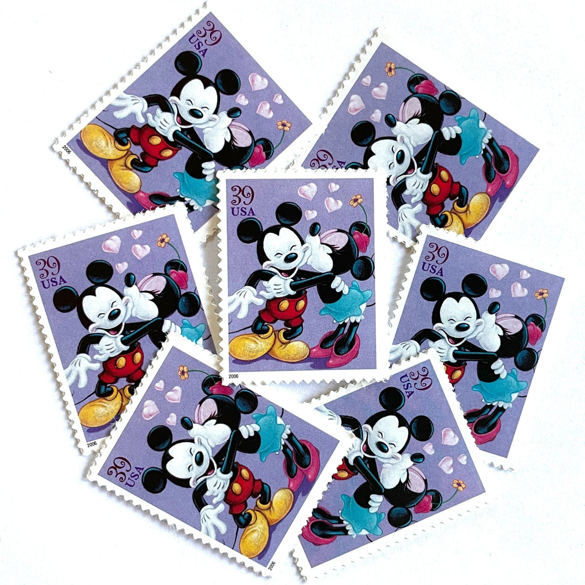Mickey and Minnie Mouse postage stamps from 2006 featuring Minnie kissing Mickey on the cheek on vintage unused 39-cent USPS postage.