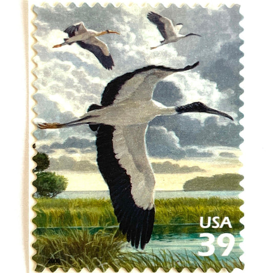 Vintage Wood Storks postage stamp from the 2006 Southern Florida Wetland issue in the Nature of America series featuring white wood storks with black wing feathers in lush Florida wetland habitat on unused 39-cent USPS postage, Scott 4099b.