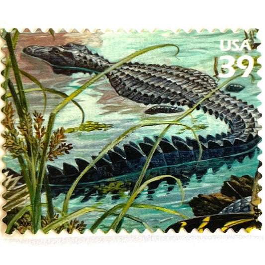 Vintage American Alligator postage stamp from the 2006 Southern Florida Wetland issue in the Nature of America series featuring an alligator moving through lush green Everglades wetlands on unused 39-cent USPS postage, Scott 4099i.
