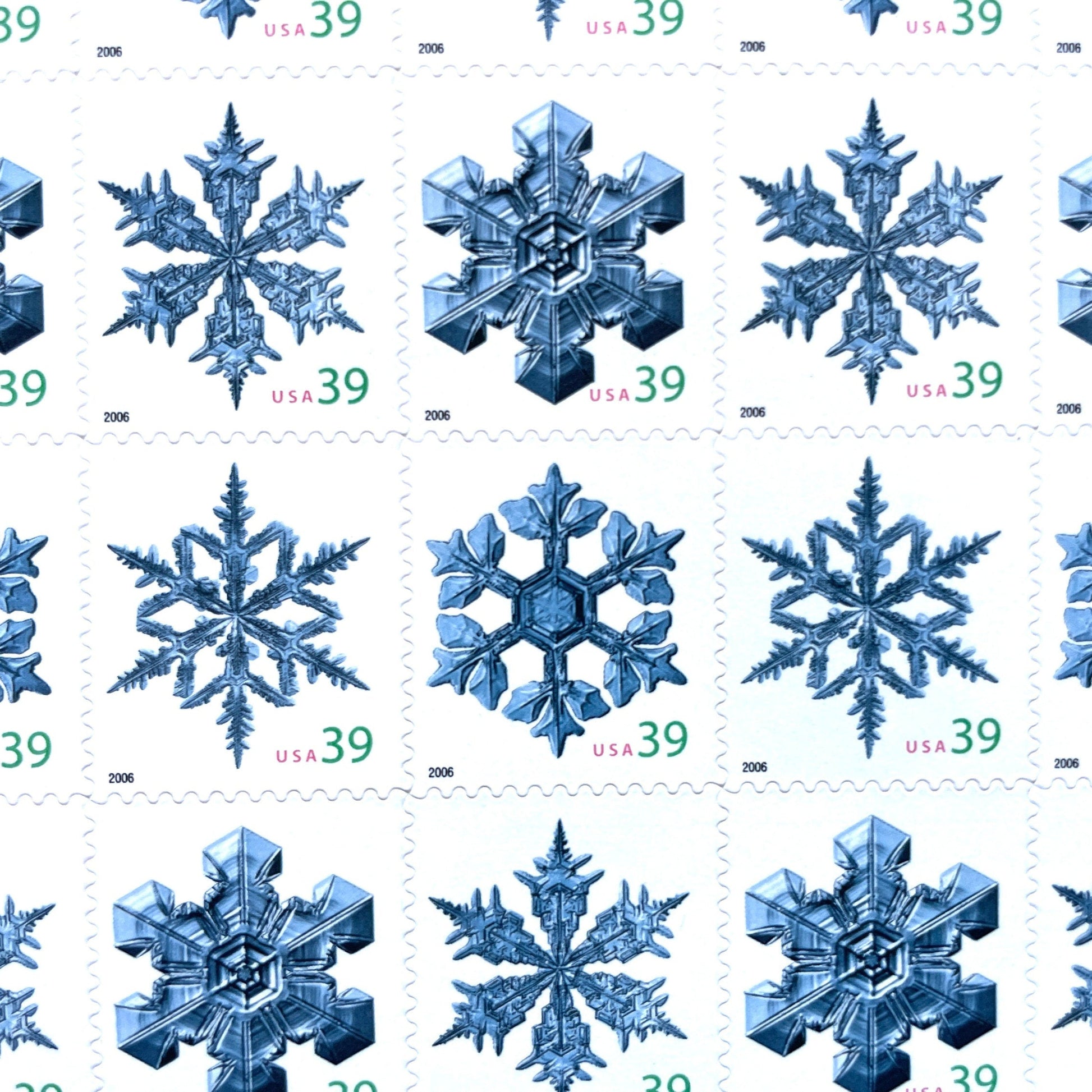 Image of four 39-cent “Holiday Snowflakes” USPS postage stamps featuring blue snowflakes on a white background from the 2006 Contemporary Christmas Series (Scott #4101, Scott #4102, Scott #4103, Scott #4104)