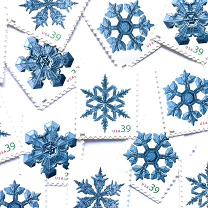 Image of four 39-cent “Holiday Snowflakes” USPS postage stamps featuring blue snowflakes on a white background from the 2006 Contemporary Christmas Series (Scott #4101, Scott #4102, Scott #4103, Scott #4104)