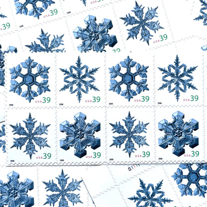 Image of four 39-cent “Holiday Snowflakes” USPS postage stamps featuring blue snowflakes on a white background from the 2006 Contemporary Christmas Series (Scott #4101, Scott #4102, Scott #4103, Scott #4104)