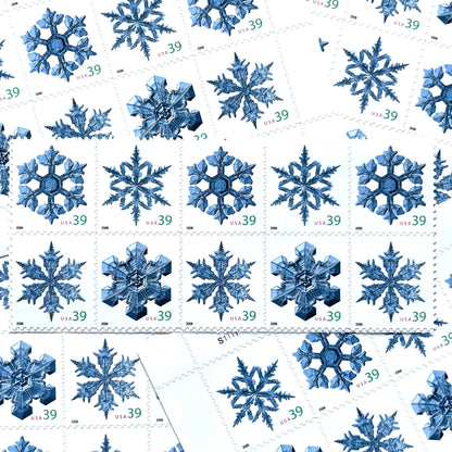 Image of four 39-cent “Holiday Snowflakes” USPS postage stamps featuring blue snowflakes on a white background from the 2006 Contemporary Christmas Series (Scott #4101, Scott #4102, Scott #4103, Scott #4104)