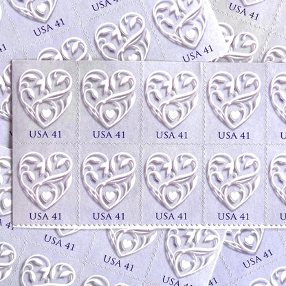Image of 2007 Wedding Series “Purple Wedding Hearts” unused 41-cent USPS mail stamps. Scott #4151. Stamp Themes: Heart, Love, Wedding, Bridal. Purple, Lavender, Violet, White, Multicolored postage stamp. Perfect postage stamp to use for save the date announcements, wedding invitation postage, shower invitations, thank you cards, valentine’s day, and snail mail.