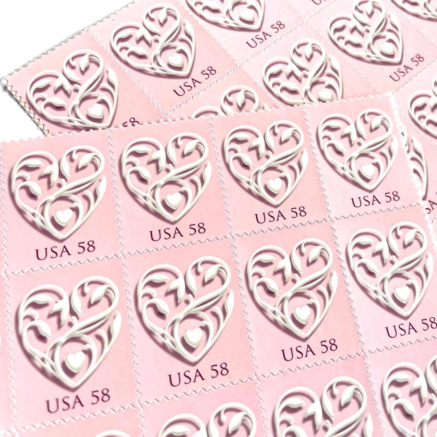 Image of 2007 Wedding Series “Pink Wedding Hearts” unused 58-cent USPS mail stamps. Scott #4152. Stamp Themes: Heart, Love, Wedding, Bridal. Pink, White, Multicolored postage stamp. Perfect postage stamp to use for save the date announcements, wedding invitation postage, shower invitations, thank you cards, valentine’s day, and snail mail.