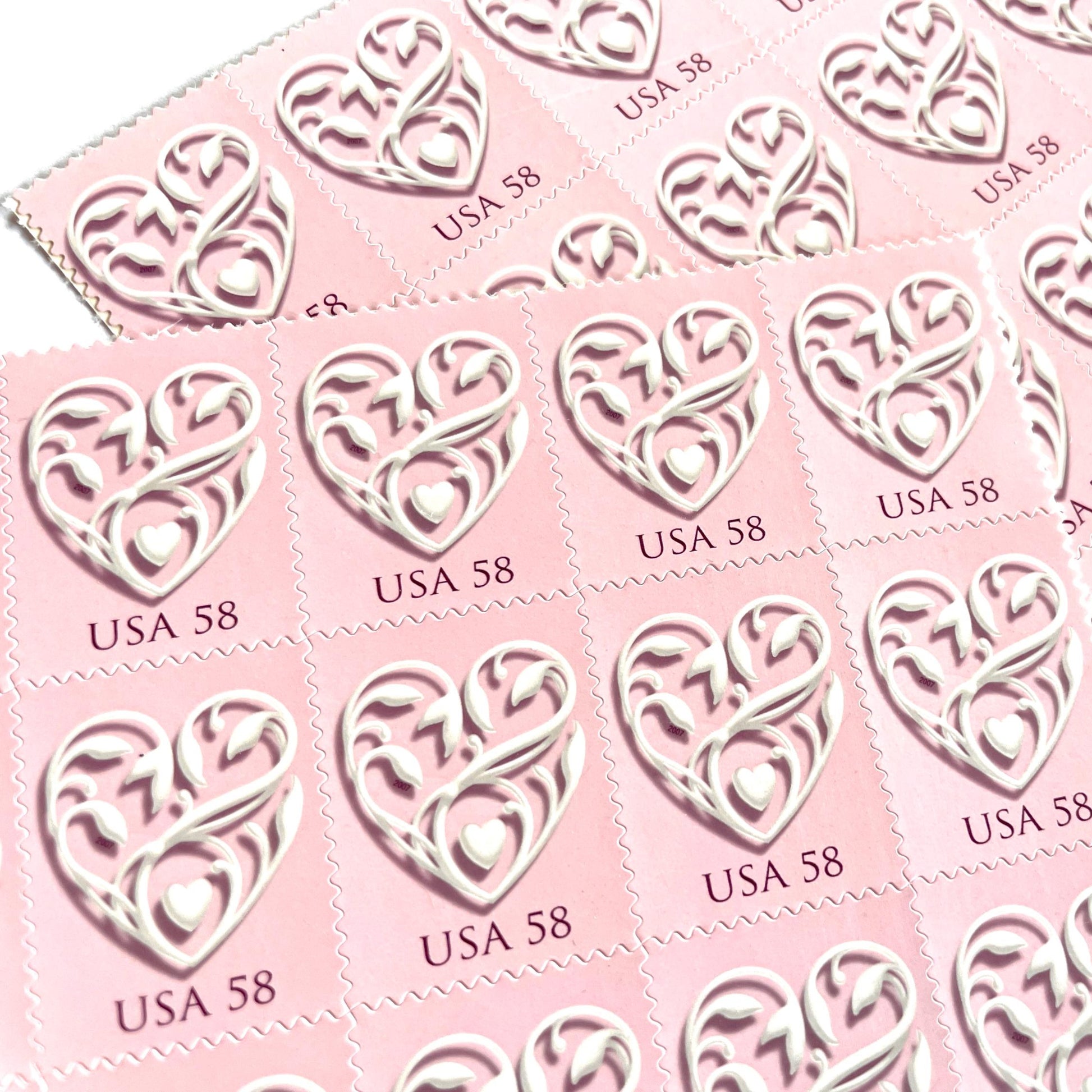 Image of 2007 Wedding Series “Pink Wedding Hearts” unused 58-cent USPS mail stamps. Scott #4152. Stamp Themes: Heart, Love, Wedding, Bridal. Pink, White, Multicolored postage stamp. Perfect postage stamp to use for save the date announcements, wedding invitation postage, shower invitations, thank you cards, valentine’s day, and snail mail.