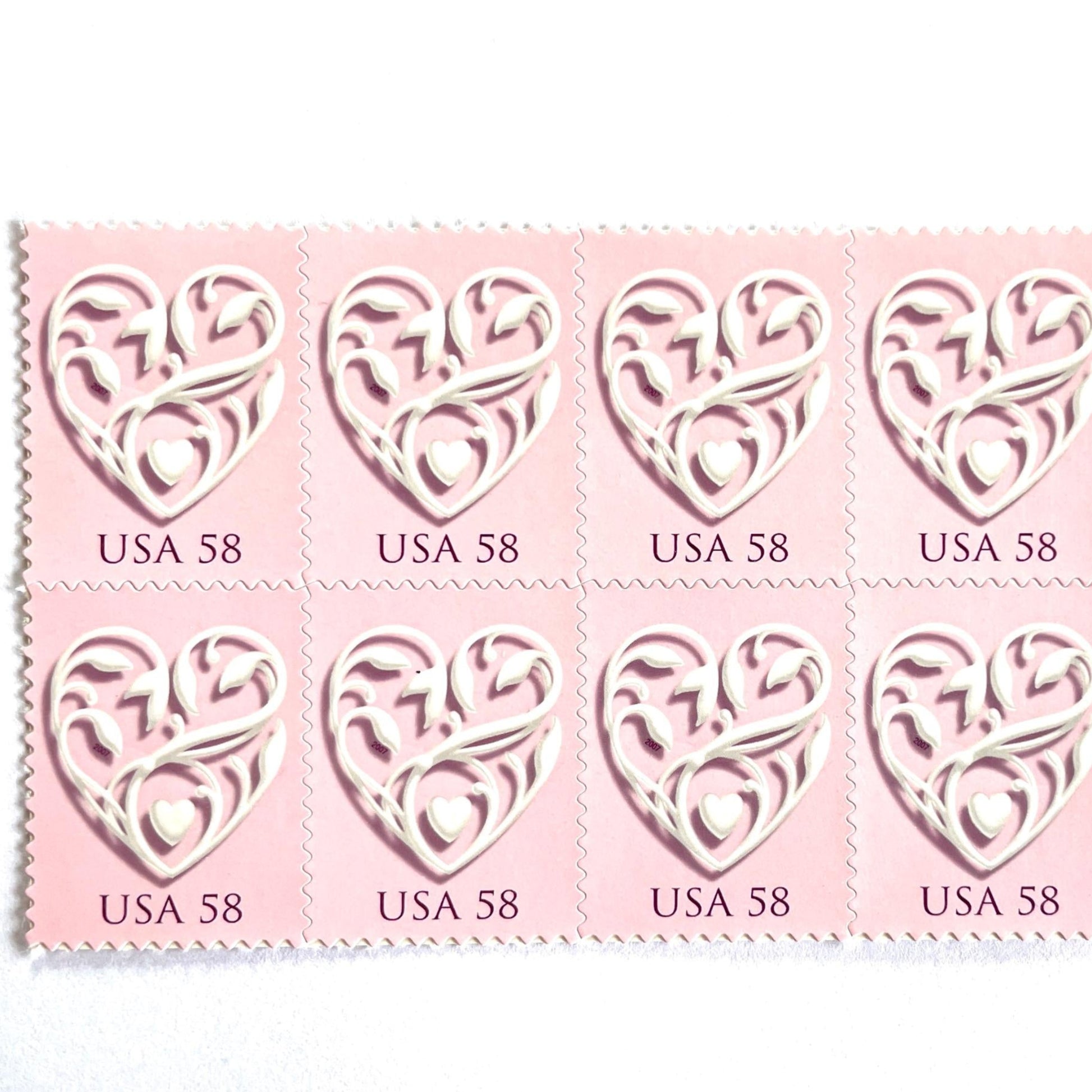 Image of 2007 Wedding Series “Pink Wedding Hearts” unused 58-cent USPS mail stamps. Scott #4152. Stamp Themes: Heart, Love, Wedding, Bridal. Pink, White, Multicolored postage stamp. Perfect postage stamp to use for save the date announcements, wedding invitation postage, shower invitations, thank you cards, valentine’s day, and snail mail.