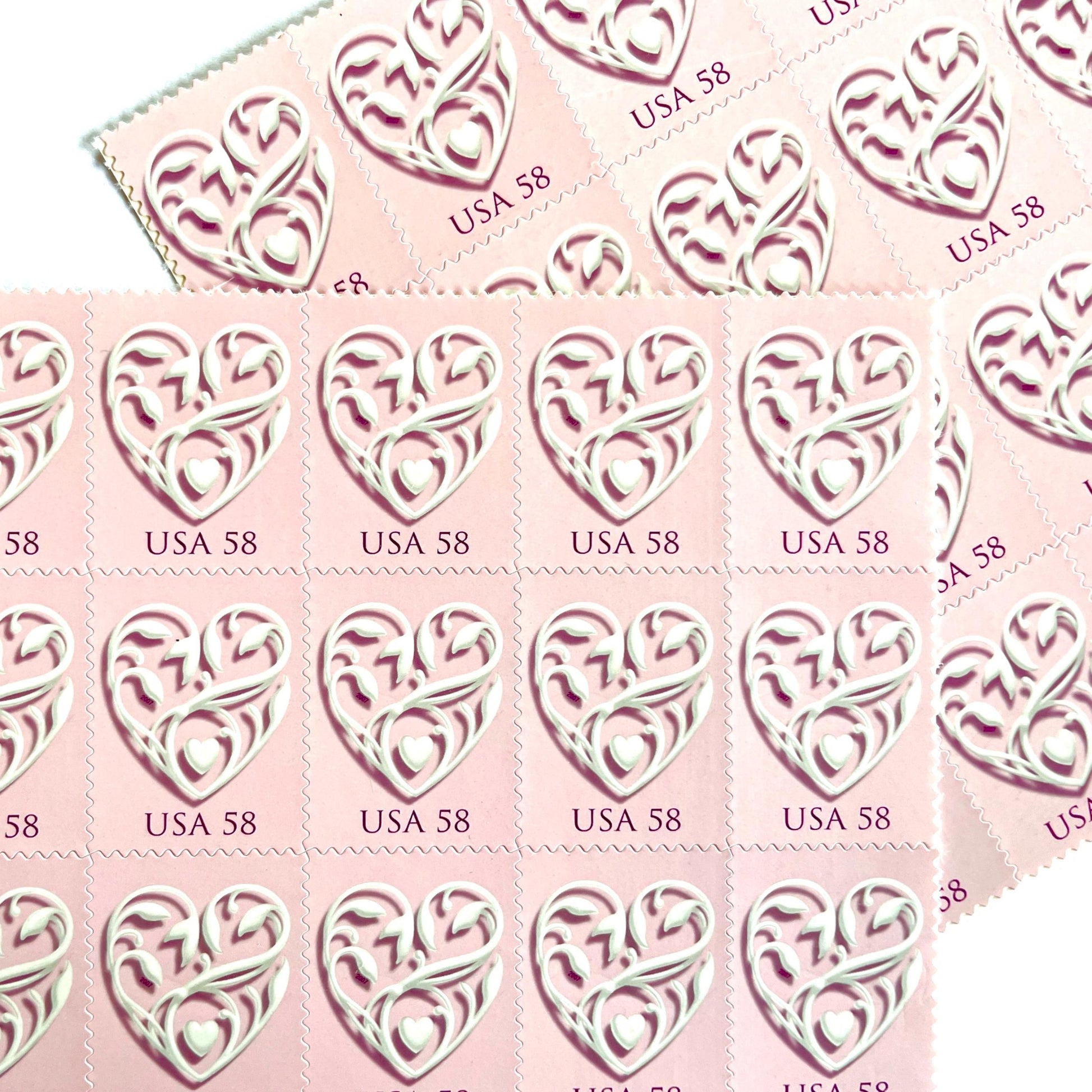 Image of 2007 Wedding Series “Pink Wedding Hearts” unused 58-cent USPS mail stamps. Scott #4152. Stamp Themes: Heart, Love, Wedding, Bridal. Pink, White, Multicolored postage stamp. Perfect postage stamp to use for save the date announcements, wedding invitation postage, shower invitations, thank you cards, valentine’s day, and snail mail.