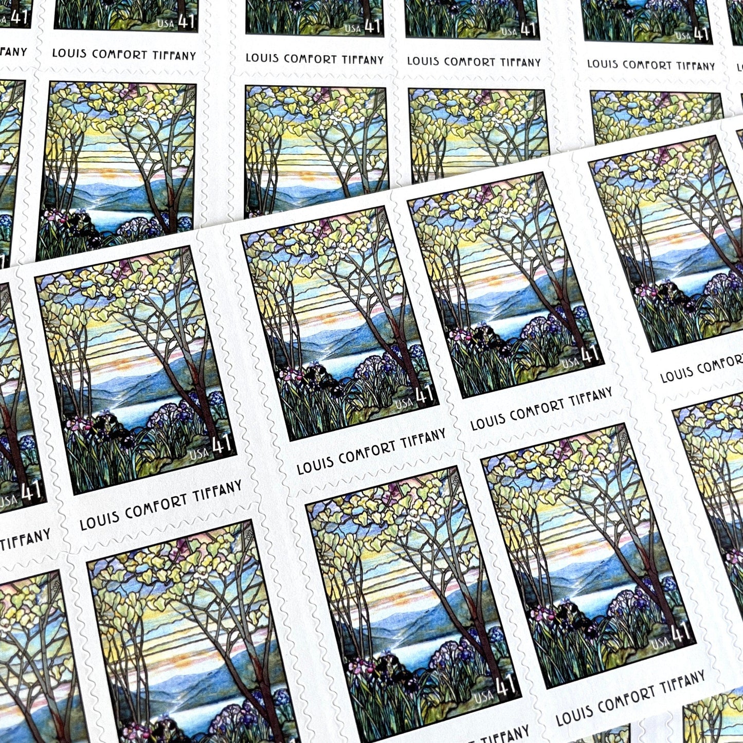 Image of 2007 American Treasures series “Louis Comfort Tiffany” (Magnolias and Irises in Stained Glass) unused 41-cent vintage USPS mail stamps. Scott #4165. Stamp Themes: Flowers, Floral, Botanical, Gardening, Nature, Tiffany Stained Glass. Purple, Blue, White, Multicolored self-adhesive postage stamp. Perfect postage stamp to use for save the date announcements, wedding invitation postage, bridal shower invitations, birth announcements, thank you cards, valentine’s day, and snail mail.