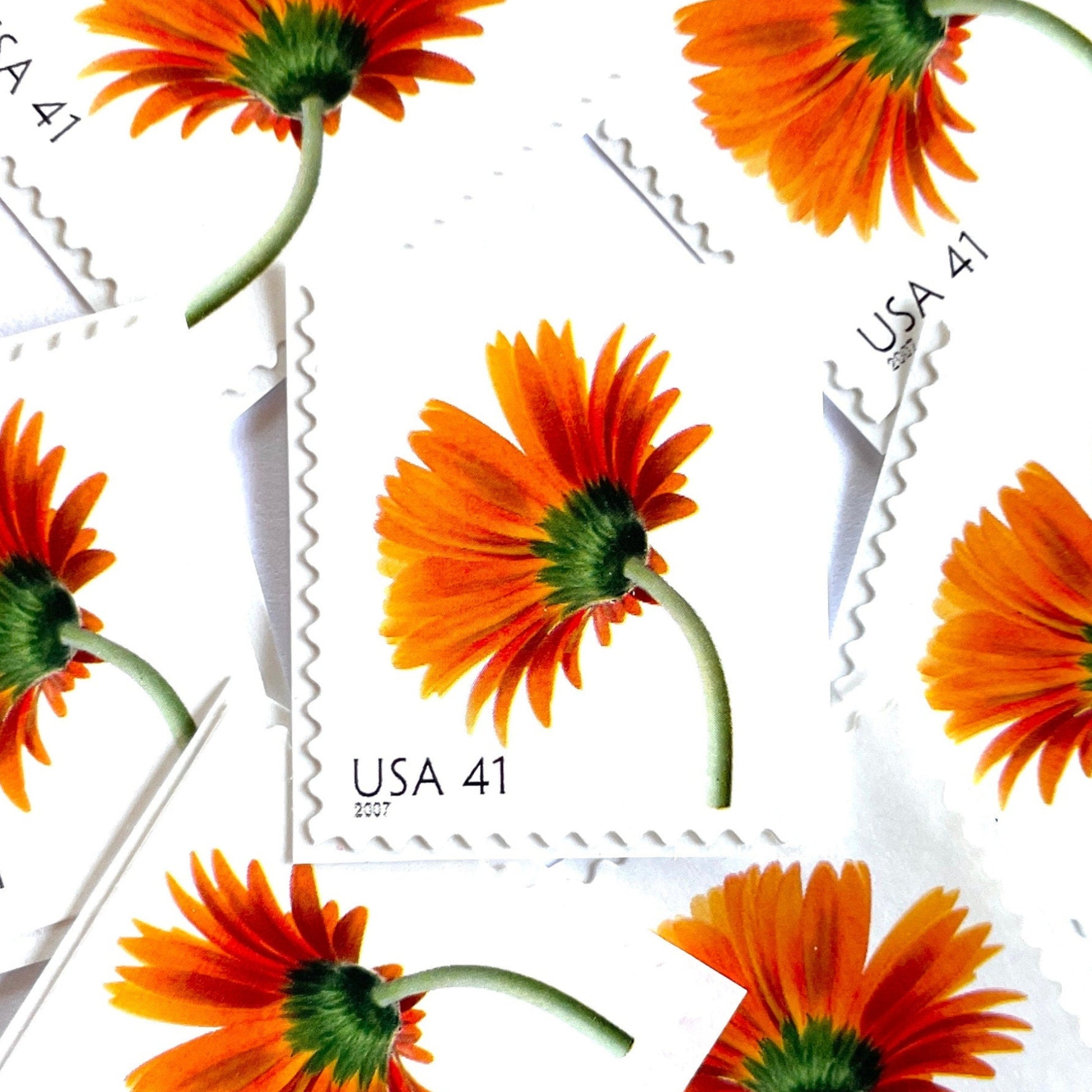 Image of 2007 Beautiful Blooms series “Orange Gerbera Daisy” unused 41-cent vintage USPS mail stamps. Scott #4177. Stamp Themes: Flowers, Floral, Botanical, Fragrant, Gardening, Nature. Orange, Green, Multicolored self-adhesive postage stamp. Perfect postage stamp to use for save the date announcements, wedding invitation postage, bridal shower invitations, birth announcements, thank you cards, valentine’s day, and snail mail.