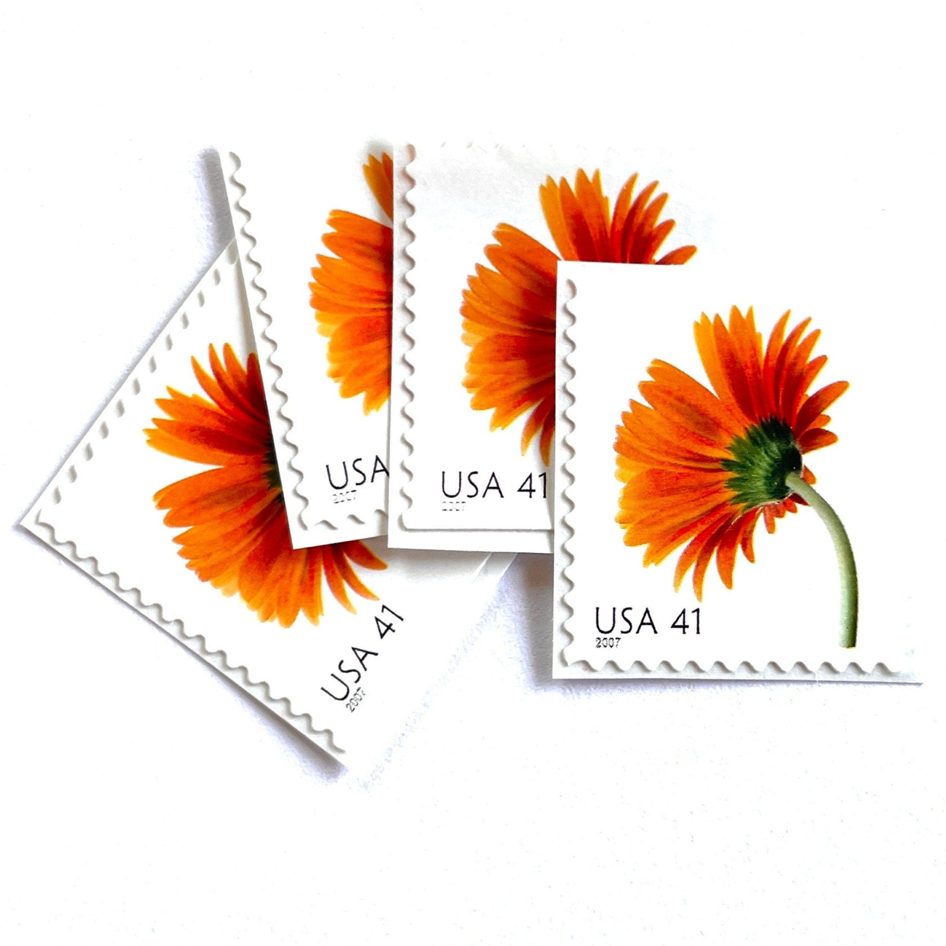 Image of 2007 Beautiful Blooms series “Orange Gerbera Daisy” unused 41-cent vintage USPS mail stamps. Scott #4177. Stamp Themes: Flowers, Floral, Botanical, Fragrant, Gardening, Nature. Orange, Green, Multicolored self-adhesive postage stamp. Perfect postage stamp to use for save the date announcements, wedding invitation postage, bridal shower invitations, birth announcements, thank you cards, valentine’s day, and snail mail.
