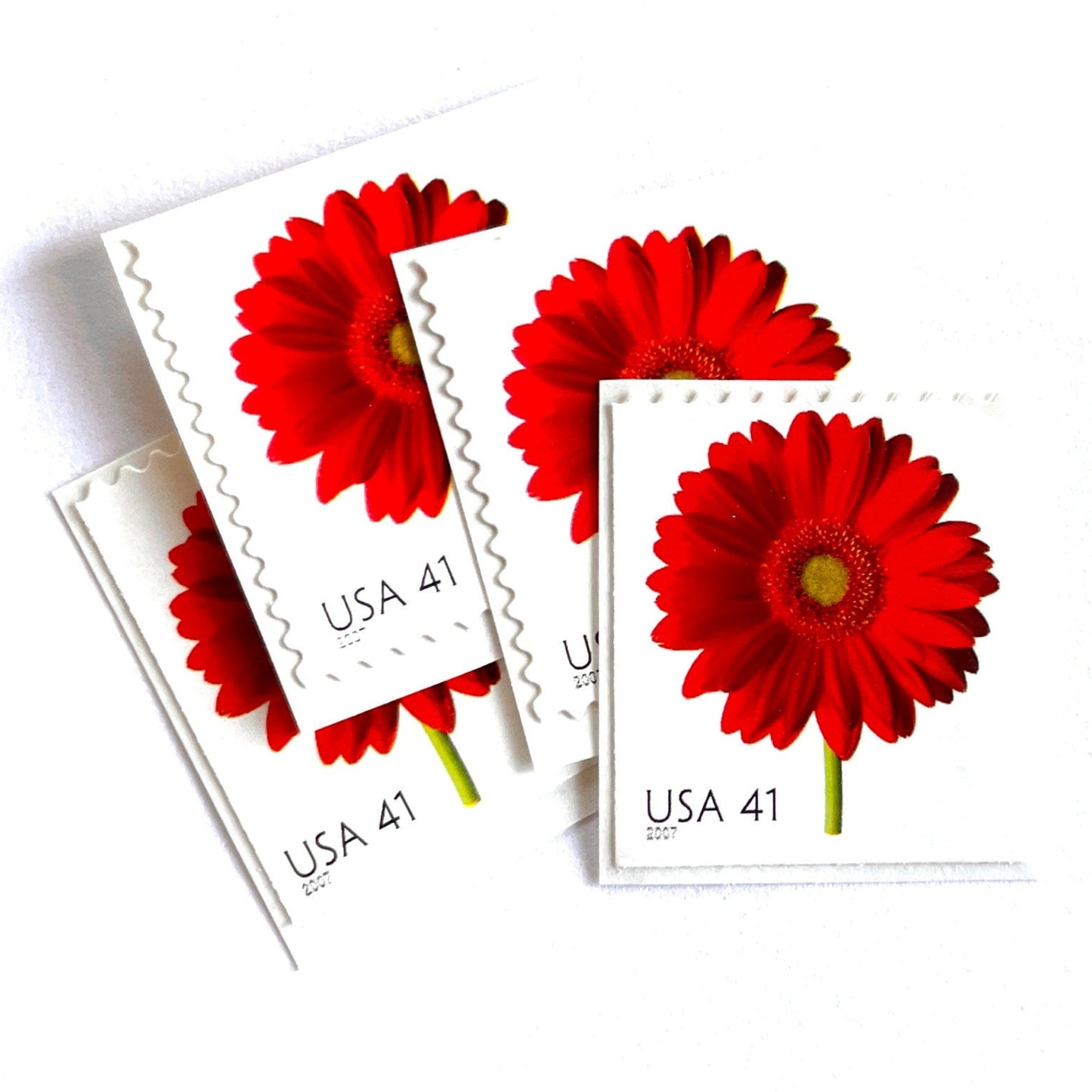 Image of 2007 Beautiful Blooms series “Red Gerbera Daisy” unused 41-cent vintage USPS mail stamps. Scott #4181. Stamp Themes: Flowers, Floral, Botanical, Fragrant, Gardening, Nature. Red, Green, Multicolored self-adhesive postage stamp. Perfect postage stamp to use for save the date announcements, wedding invitation postage, bridal shower invitations, birth announcements, thank you cards, valentine’s day, and snail mail.
