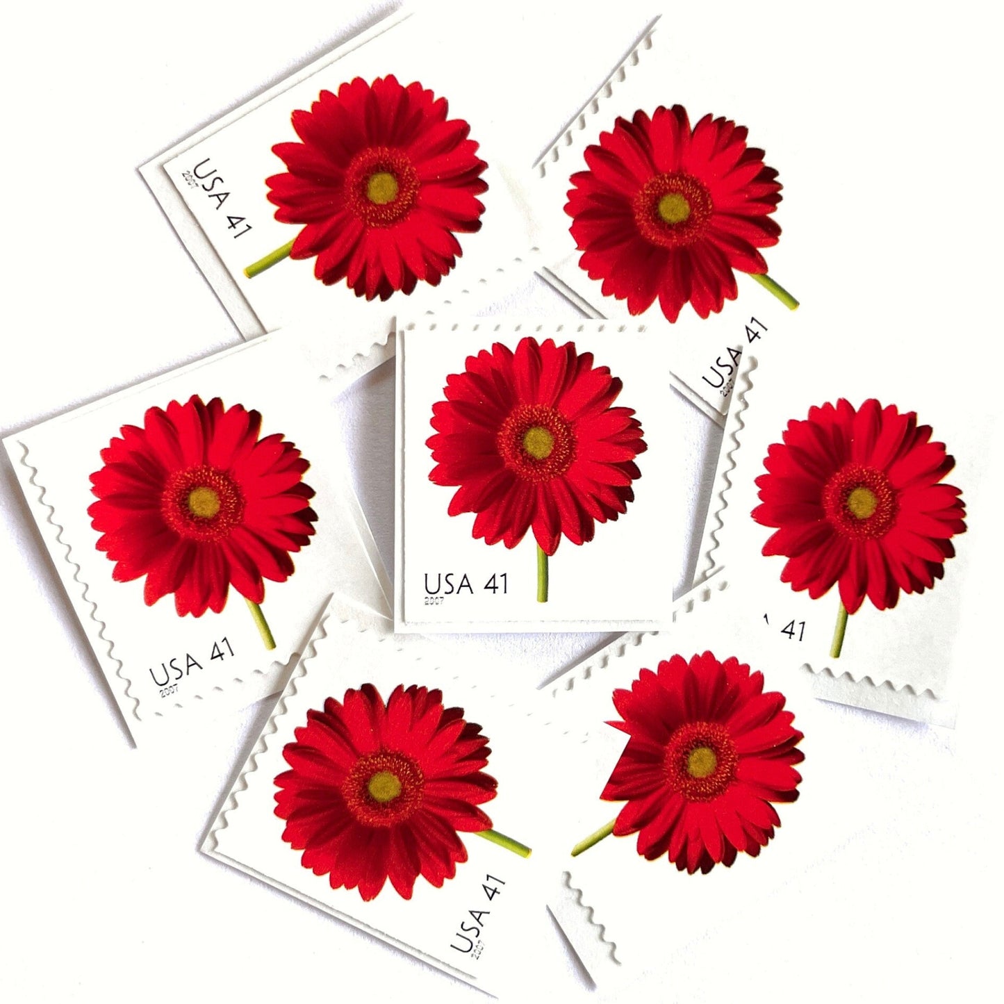 Image of 2007 Beautiful Blooms series “Red Gerbera Daisy” unused 41-cent vintage USPS mail stamps. Scott #4181. Stamp Themes: Flowers, Floral, Botanical, Fragrant, Gardening, Nature. Red, Green, Multicolored self-adhesive postage stamp. Perfect postage stamp to use for save the date announcements, wedding invitation postage, bridal shower invitations, birth announcements, thank you cards, valentine’s day, and snail mail.