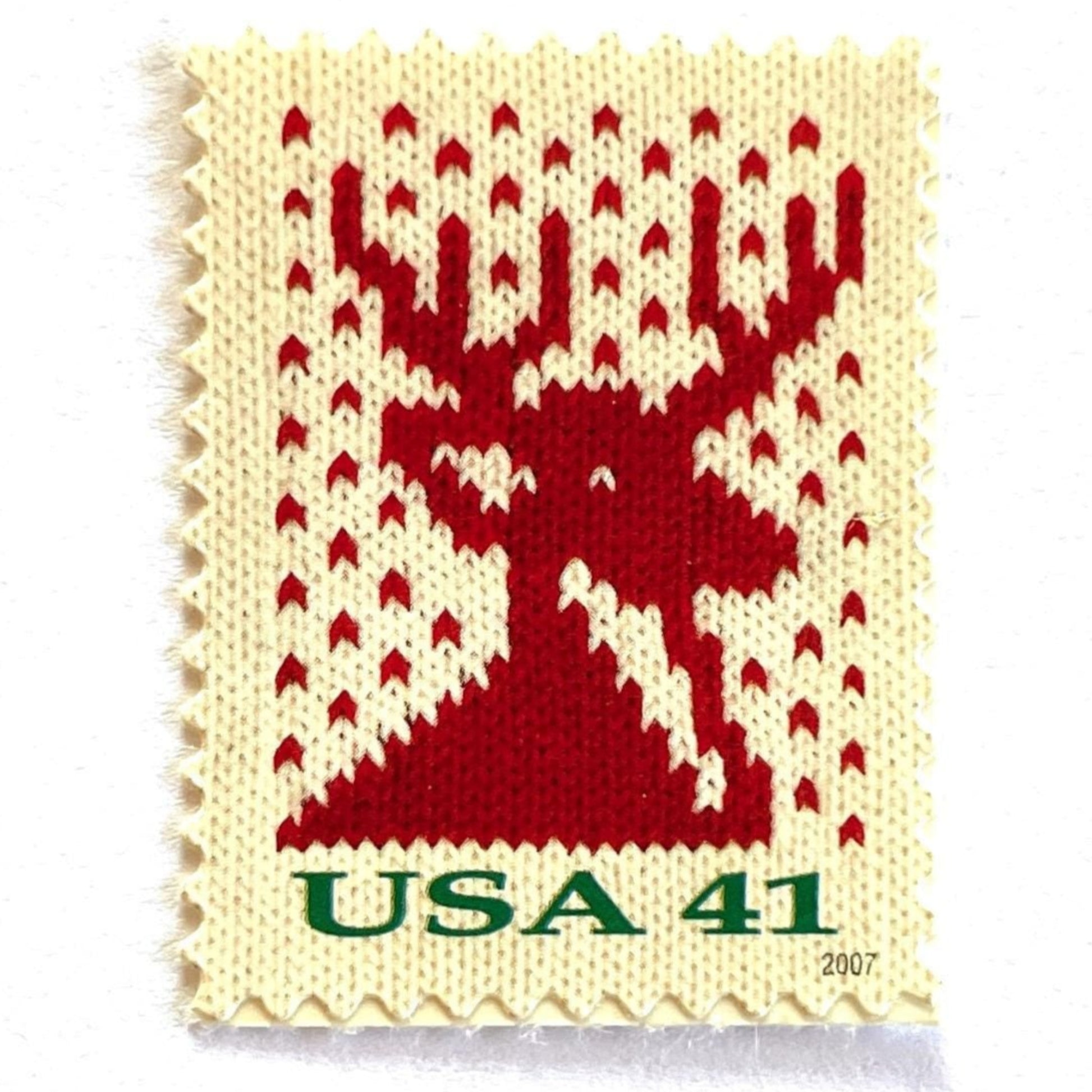Image of 41-cent Contemporary Christmas Holiday Knits Reindeer USPS postage stamp featuring a red/orange knit reindeer on white background. Scott #4207. Themes: Christmas, Holidays, Winter, Reindeer, Deer, Stag, Stud, reindeer, deer, stag, orange, hunting, hunter, deer hunting, stag party, bachelor party, bachelor, stud, Red and White Stamp.