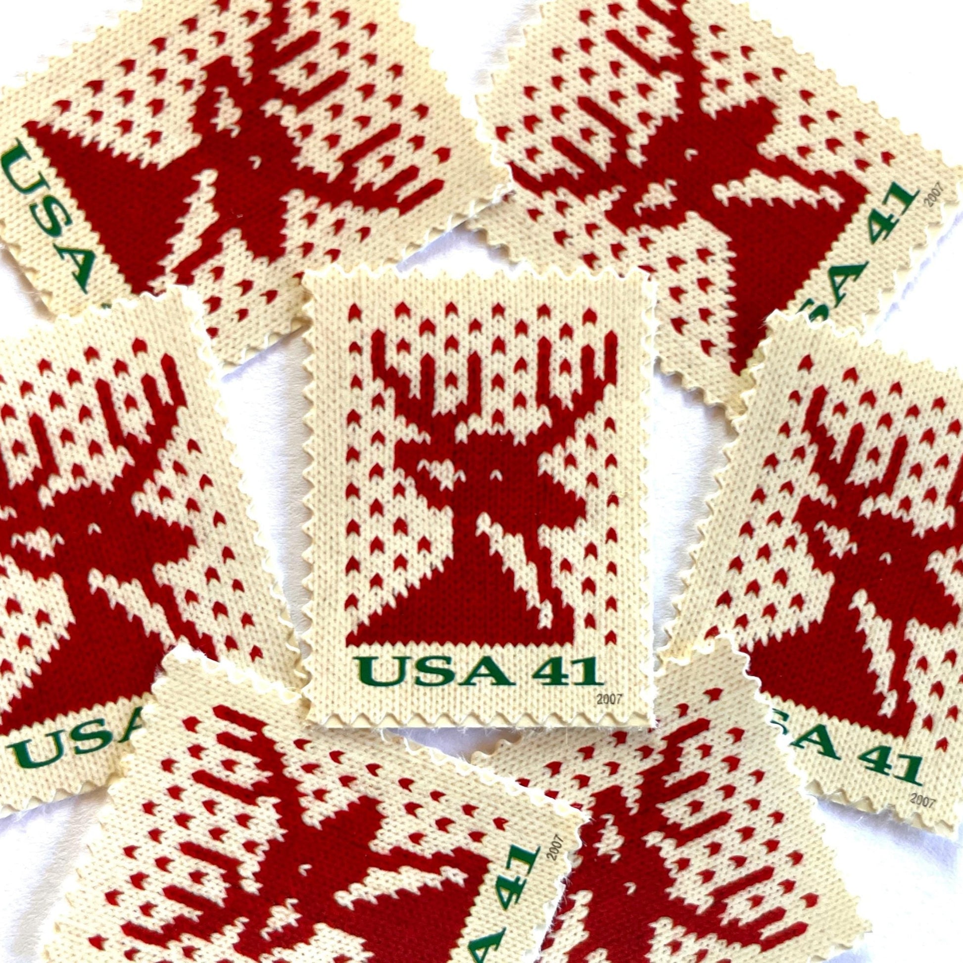 Image of 41-cent Contemporary Christmas Holiday Knits Reindeer USPS postage stamp featuring a red/orange knit reindeer on white background. Scott #4207. Themes: Christmas, Holidays, Winter, Reindeer, Deer, Stag, Stud, reindeer, deer, stag, orange, hunting, hunter, deer hunting, stag party, bachelor party, bachelor, stud, Red and White Stamp.