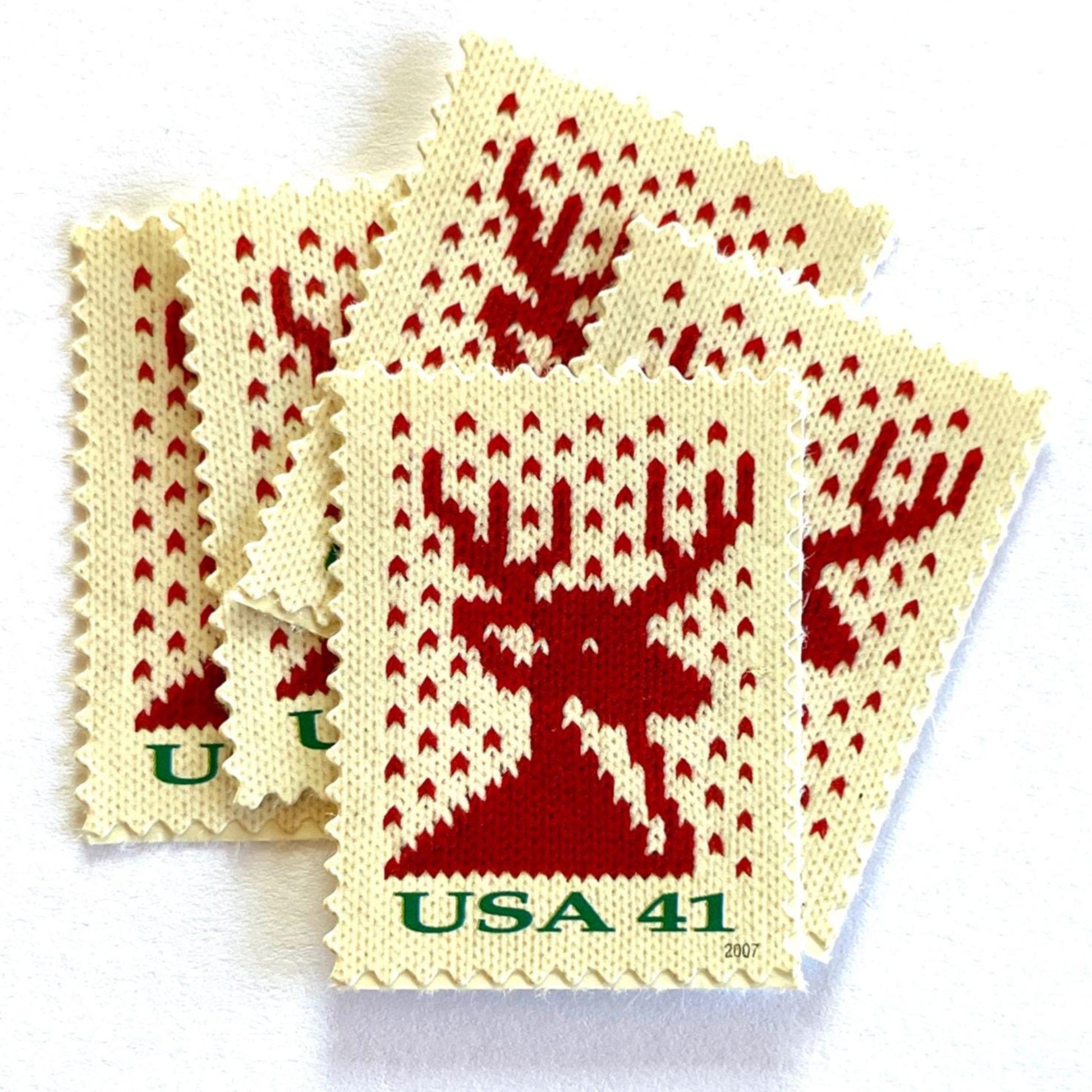 Image of 41-cent Contemporary Christmas Holiday Knits Reindeer USPS postage stamp featuring a red/orange knit reindeer on white background. Scott #4207. Themes: Christmas, Holidays, Winter, Reindeer, Deer, Stag, Stud, reindeer, deer, stag, orange, hunting, hunter, deer hunting, stag party, bachelor party, bachelor, stud, Red and White Stamp.
