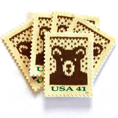 Image of 41-cent Contemporary Christmas Holiday Knits Bear USPS postage stamps featuring a brown knit teddy bear on white background. Scott #4210. Themes: Christmas, Holidays, Winter, Bear, Teddy Bear, Brown and White Stamp.