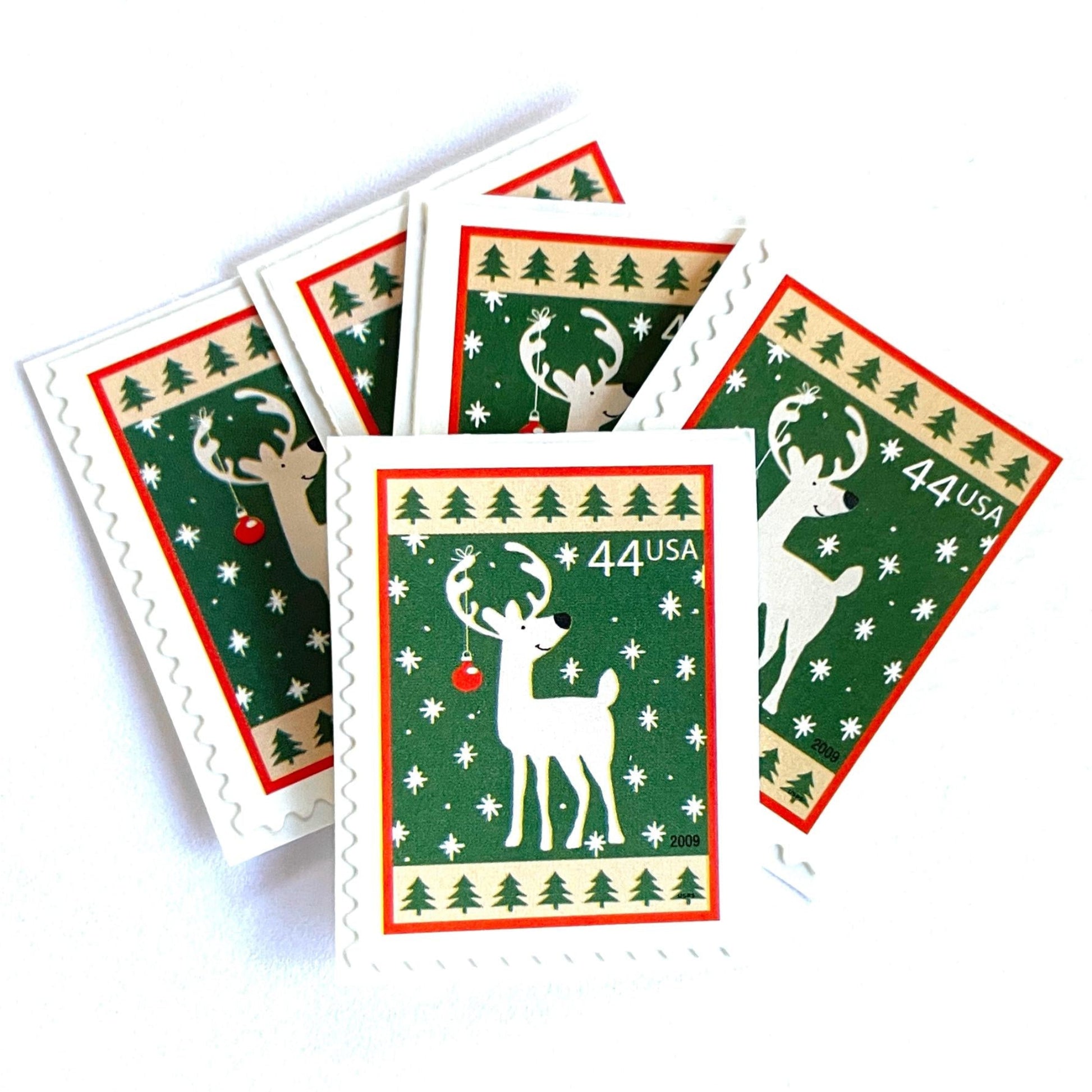Image of 44-cent Contemporary Christmas Winter Holidays Reindeer USPS postage stamp featuring a reindeer on green and white background with a design reminiscent of Christmas wrapping paper. Scott #4425. Stamp themes: Christmas, holidays, winter, reindeer, deer, stag, reindeer, winter wedding, winter save-the-date. Green postage stamp.