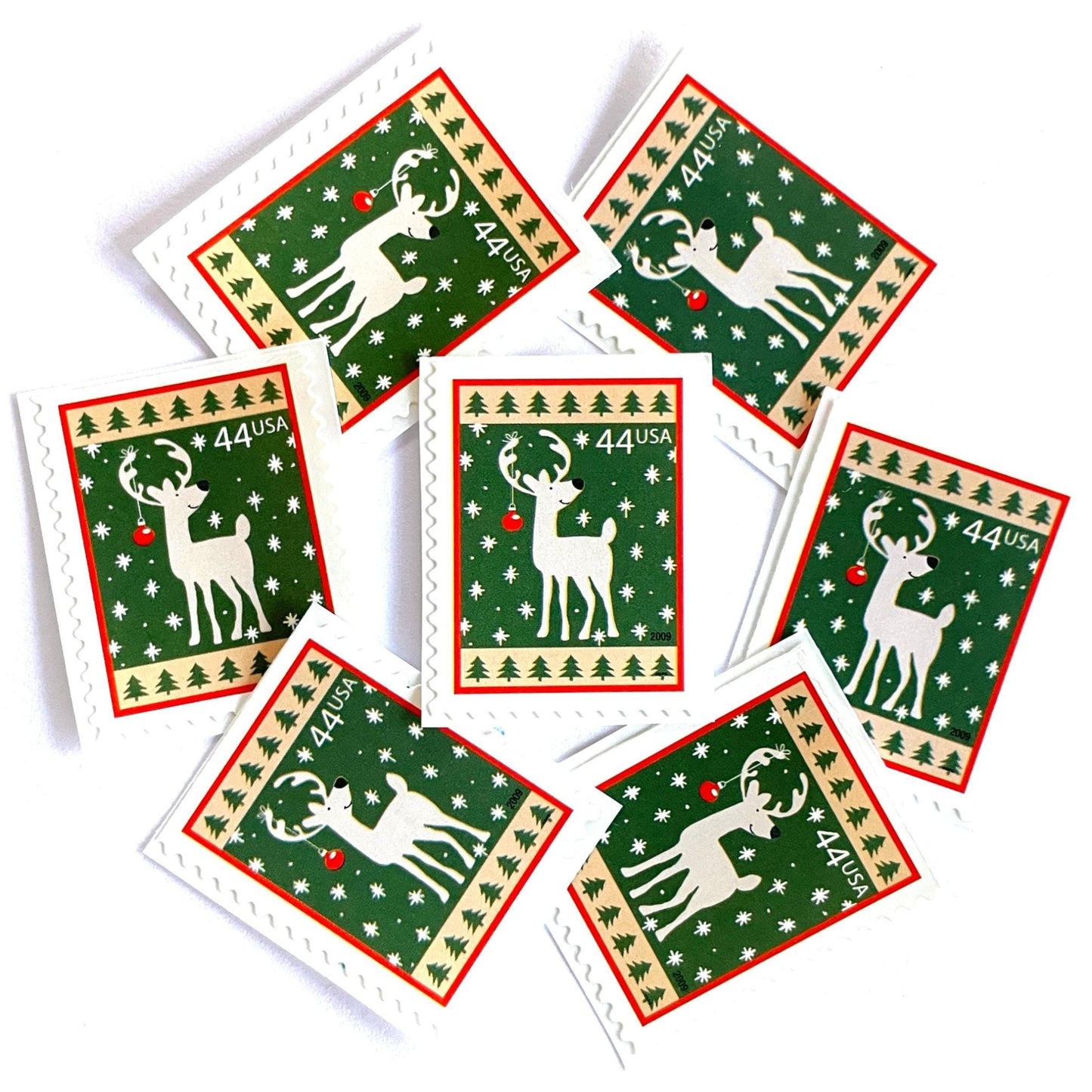 Image of 44-cent Contemporary Christmas Winter Holidays Reindeer USPS postage stamp featuring a reindeer on green and white background with a design reminiscent of Christmas wrapping paper. Scott #4425. Stamp themes: Christmas, holidays, winter, reindeer, deer, stag, reindeer, winter wedding, winter save-the-date. Green postage stamp.