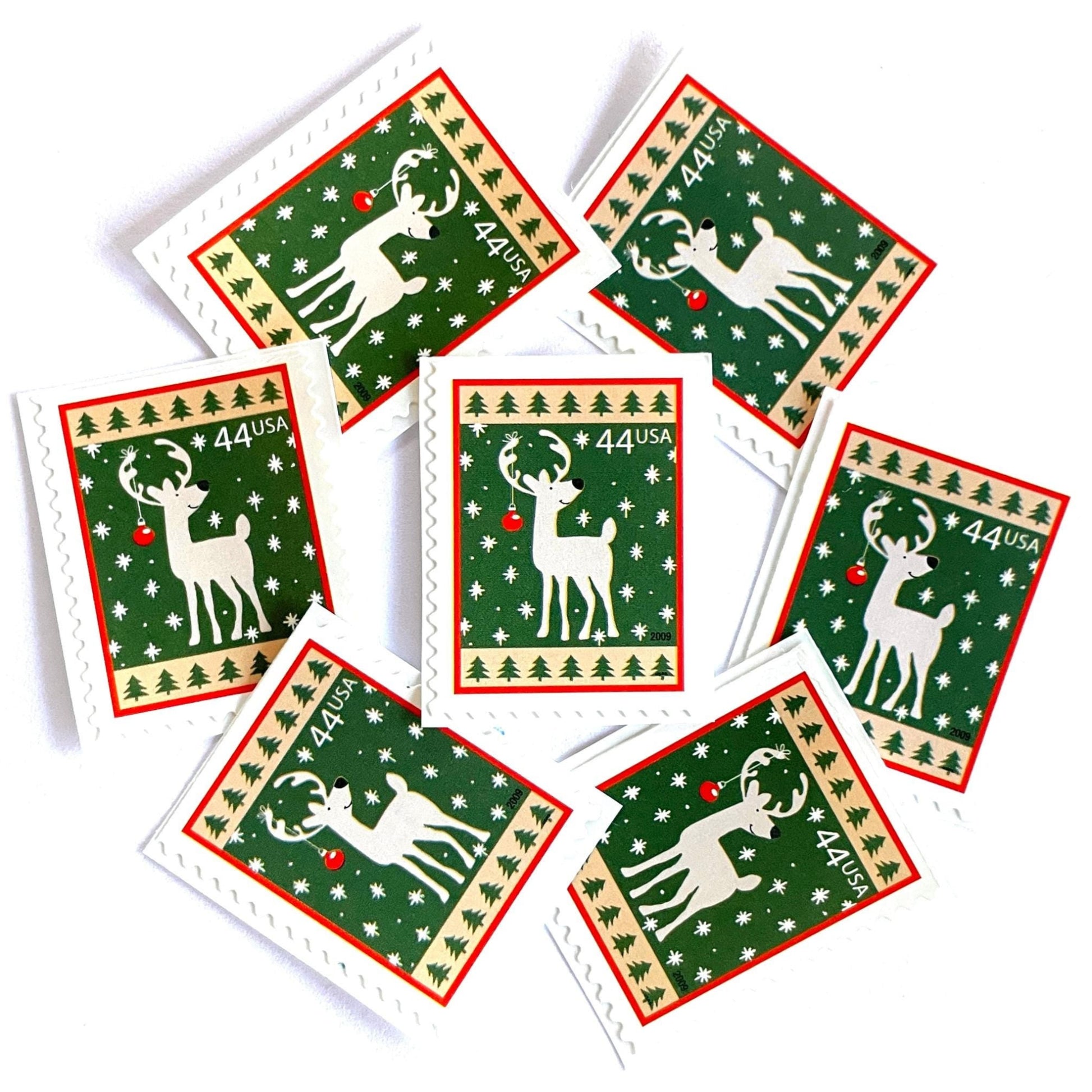 Image of 44-cent Contemporary Christmas Winter Holidays Reindeer USPS postage stamp featuring a reindeer on green and white background with a design reminiscent of Christmas wrapping paper. Scott #4425. Stamp themes: Christmas, holidays, winter, reindeer, deer, stag, reindeer, winter wedding, winter save-the-date. Green postage stamp.