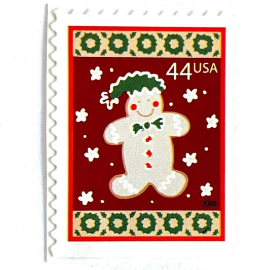 Image of 44-cent Contemporary Christmas Winter Holidays Gingerbread Man USPS postage stamp featuring a beige gingerbread man and snowflakes against a red background with a design reminiscent of Christmas wrapping paper. Scott #4427. Stamp themes: Christmas, holidays, winter, snowflakes, baking, icing, cookies, winter wedding, winter save-the-date. Red postage stamp.