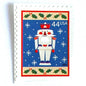 Image of 44-cent Contemporary Christmas Winter Holidays Toy Soldier USPS postage stamp featuring a smiling toy soldier standing at attention, set against a blue background with white snowflakes falling, evoking the imagery of classic holiday stories like “The Nutcracker,” with a design reminiscent of Christmas wrapping paper. Scott #4428. Stamp themes: Christmas, holidays, winter, snowflakes, toys, wooden toys, nutcracker, German, winter wedding, winter save-the-date. Blue postage stamp.
