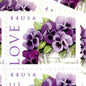 Pansies in a Basket postage stamp from 2010 featuring purple pansies and green foliage in a white woven cart on vintage unused 44-cent USPS postage, Scott 4450.
