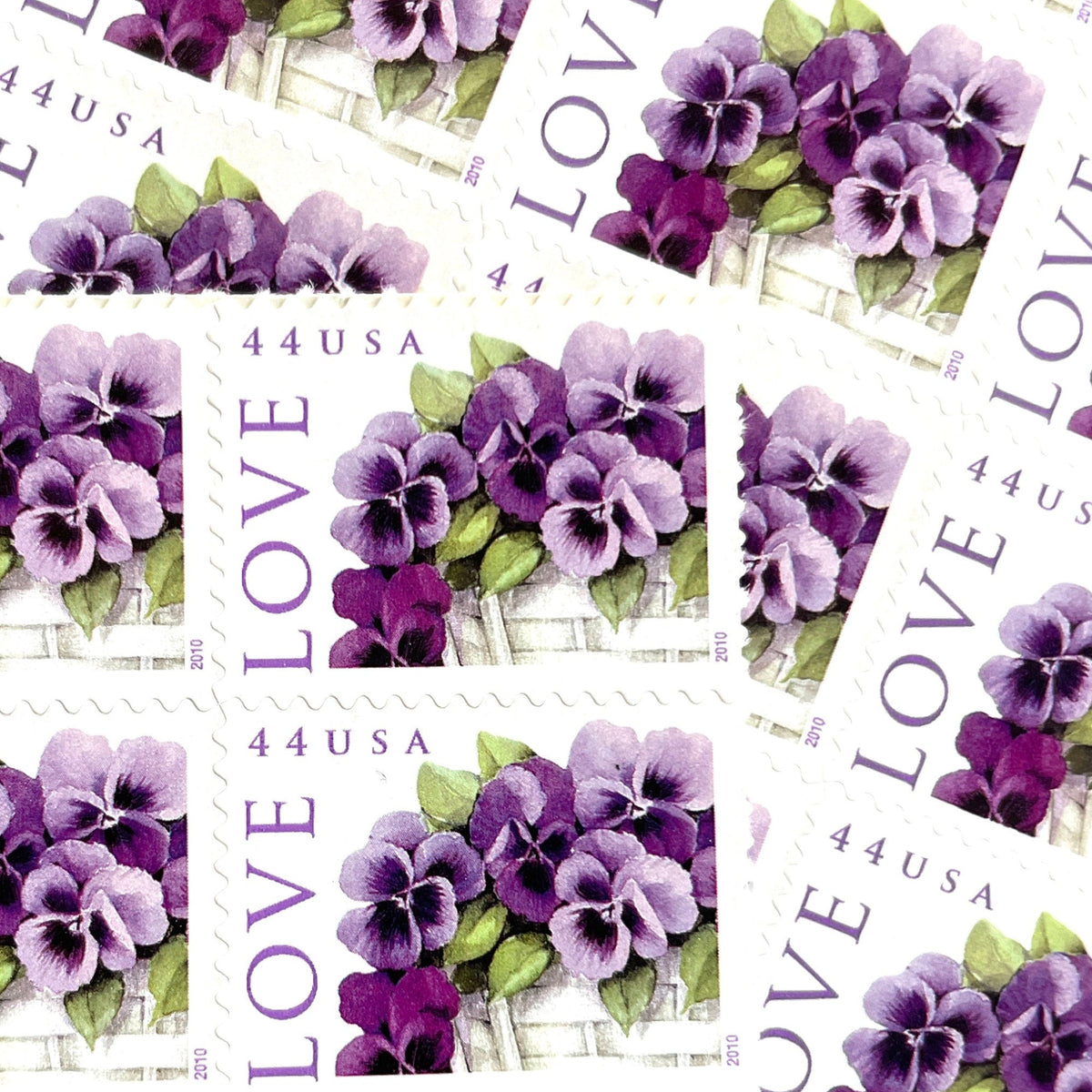 Pansies in a Basket postage stamps from 2010 featuring purple pansies and green foliage in a white woven cart on vintage unused 44-cent USPS postage, Scott 4450.