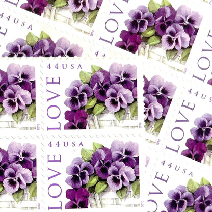 Pansies in a Basket postage stamps from 2010 featuring purple pansies and green foliage in a white woven cart on vintage unused 44-cent USPS postage, Scott 4450.