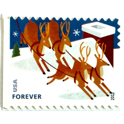 Reindeer Over Roof postage stamp from 2012 featuring flying Christmas reindeer above snow-covered rooftops in a wintry night scene on unused USPS Forever postage, Scott 4714.