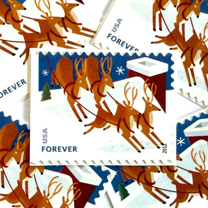 Reindeer Over Roof postage stamps from 2012 featuring flying Christmas reindeer above snow-covered rooftops in a wintry night scene on unused USPS Forever postage, Scott 4714.