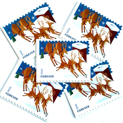 Reindeer Over Roof postage stamps from 2012 featuring flying Christmas reindeer above snow-covered rooftops in a wintry night scene on unused USPS Forever postage, Scott 4714.