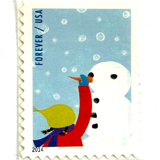 Child Making a Snowman postage stamps from 2014 featuring a child adding a carrot nose to a cheerful snowman in a snowy winter scene on unused USPS Forever postage, Scott 4938.