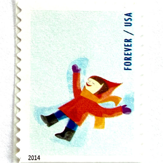 Snow Angel postage stamp from 2014 featuring a child making a classic snow angel in fresh winter snow on unused USPS Forever postage, Scott 4940.