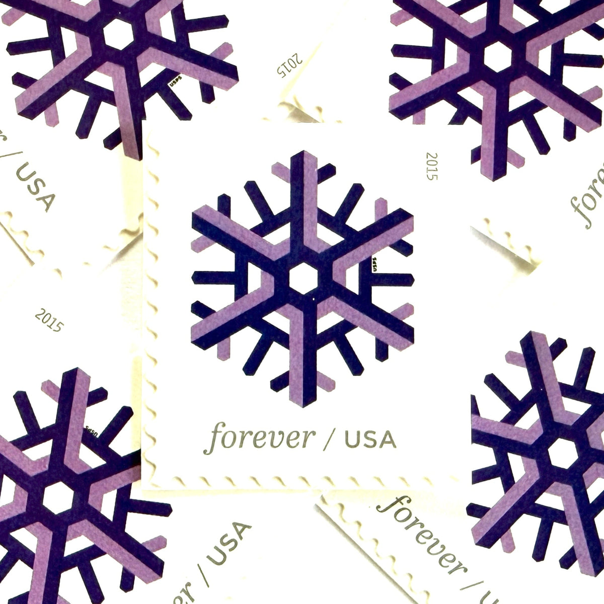 Purple and lilac Geometric Snowflake postage stamps from 2015 featuring a stylized crystalline winter design on unused USPS Forever postage, Scott 5031.