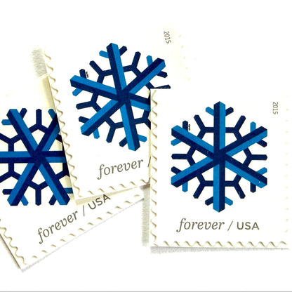 Dark blue and blue Geometric Snowflake postage stamps from 2015 featuring a stylized crystalline winter design on unused USPS Forever postage, Scott 5032.