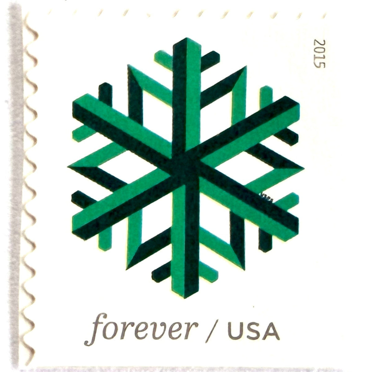 Green Geometric Snowflake postage stamp from 2015 featuring a stylized crystalline winter design on unused USPS Forever postage, Scott 5033.