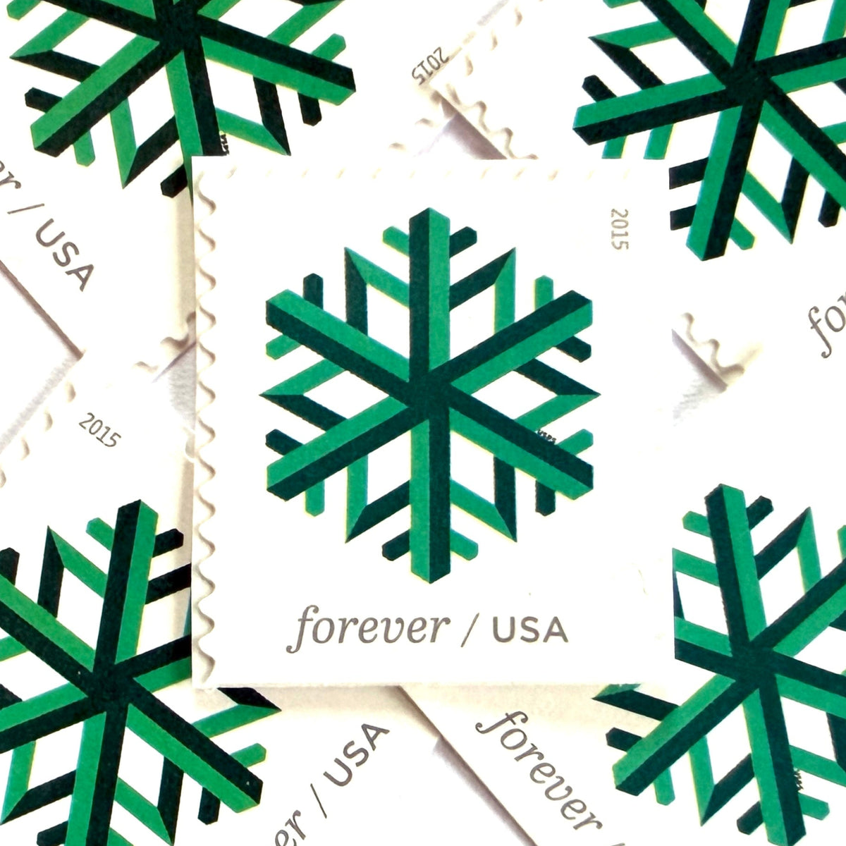 Green Geometric Snowflake postage stamps from 2015 featuring a stylized crystalline winter design on unused USPS Forever postage, Scott 5033.