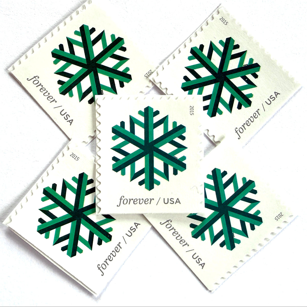 Green Geometric Snowflake postage stamps from 2015 featuring a stylized crystalline winter design on unused USPS Forever postage, Scott 5033.