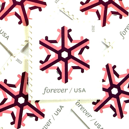 Pink and dark red Geometric Snowflake postage stamps from 2015 featuring a stylized crystalline winter design on unused USPS Forever postage, Scott 5034.