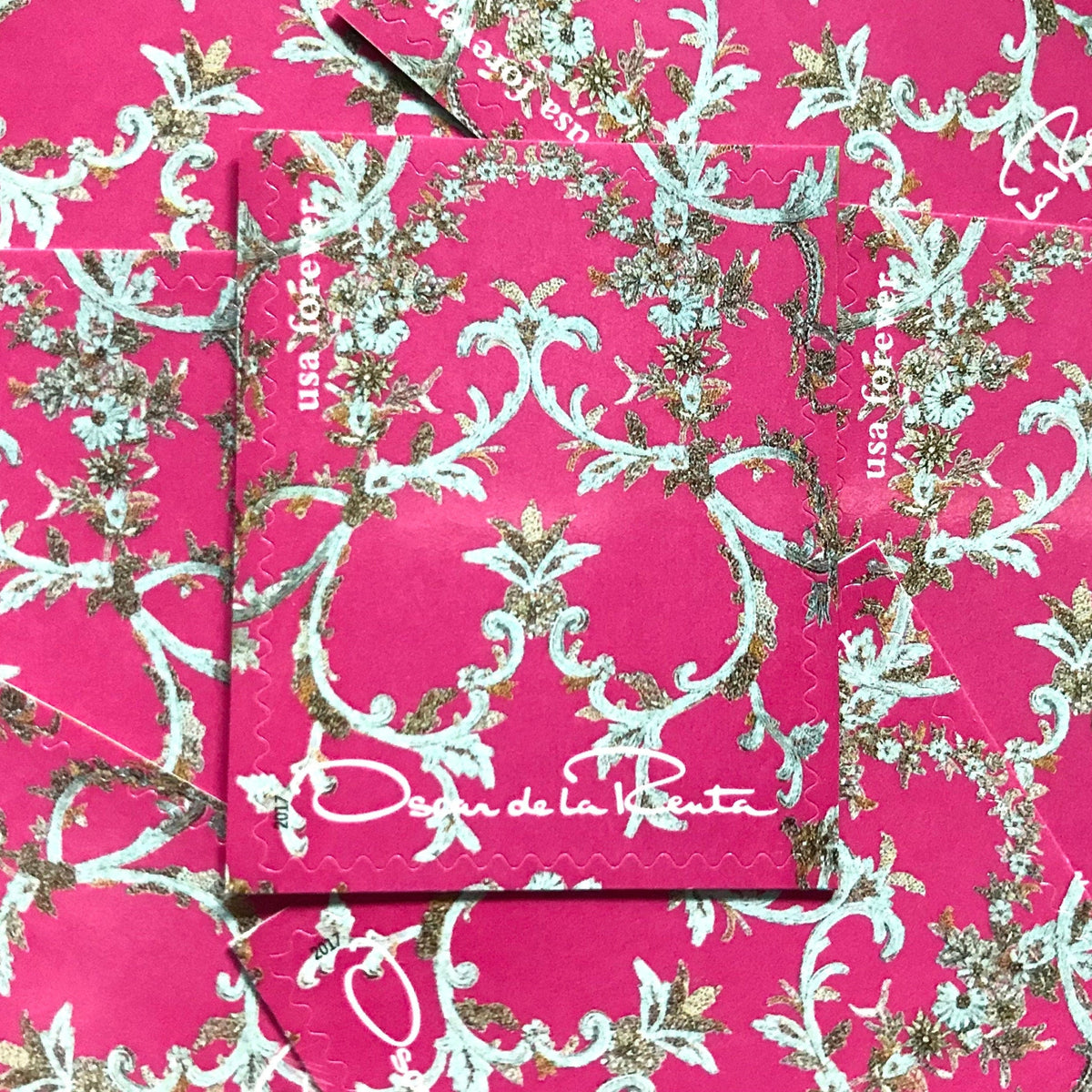 Oscar de la Renta Pink Fabric postage stamps from 2017 featuring bright pink fabric with metallic floral design on unused USPS Forever postage, Scott 5173b.