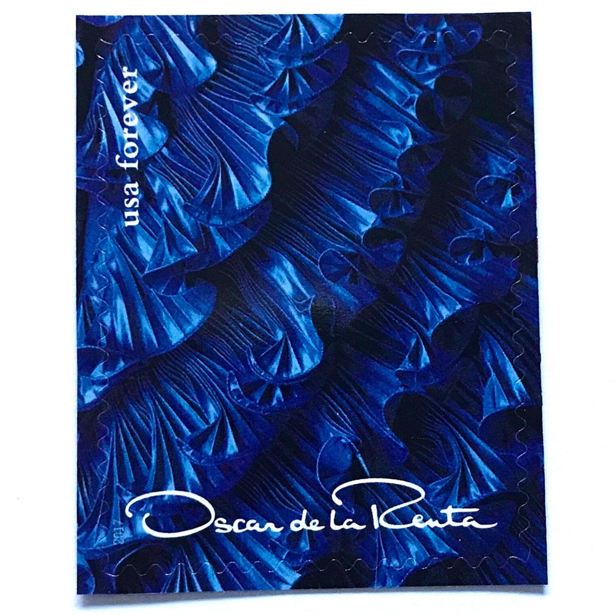 Oscar de la Renta Blue Dress Ruffles postage stamp from 2017 featuring a blue couture dress with ruffled detail on unused USPS Forever postage, Scott 5173g.