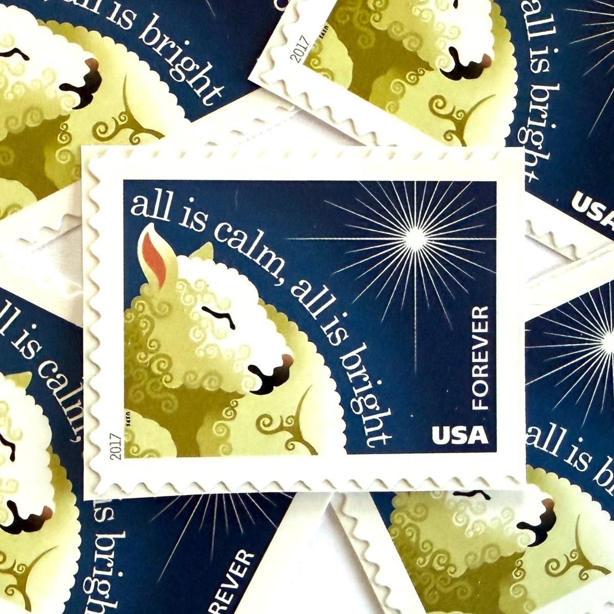 Silent Night postage stamps from 2017 featuring a sheep beneath a peaceful evening sky inspired by the classic Christmas carol on unused USPS Forever postage, Scott 5248.