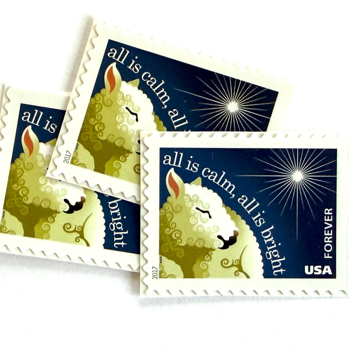 Silent Night postage stamps from 2017 featuring a sheep beneath a peaceful evening sky inspired by the classic Christmas carol on unused USPS Forever postage, Scott 5248.
