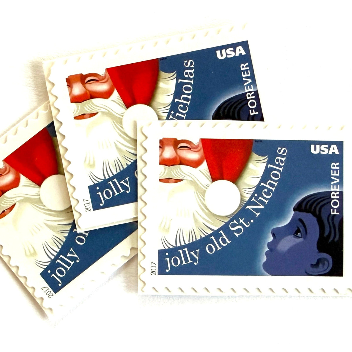 Jolly Old Saint Nicholas postage stamps from 2017 featuring Santa Claus with a child inspired by the traditional Christmas carol on unused USPS Forever postage, Scott 5250.