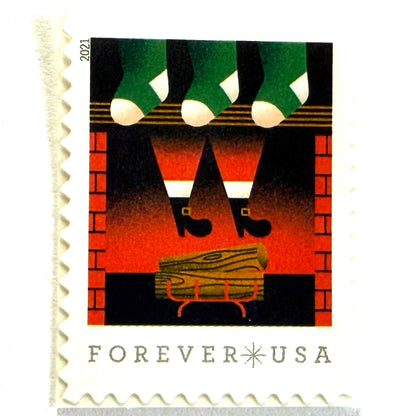 Santa Descending Chimney postage stamp from 2021 featuring St. Nick’s black-booted legs above a red-brick fireplace with green stockings on unused USPS Forever postage, Scott 5645.
